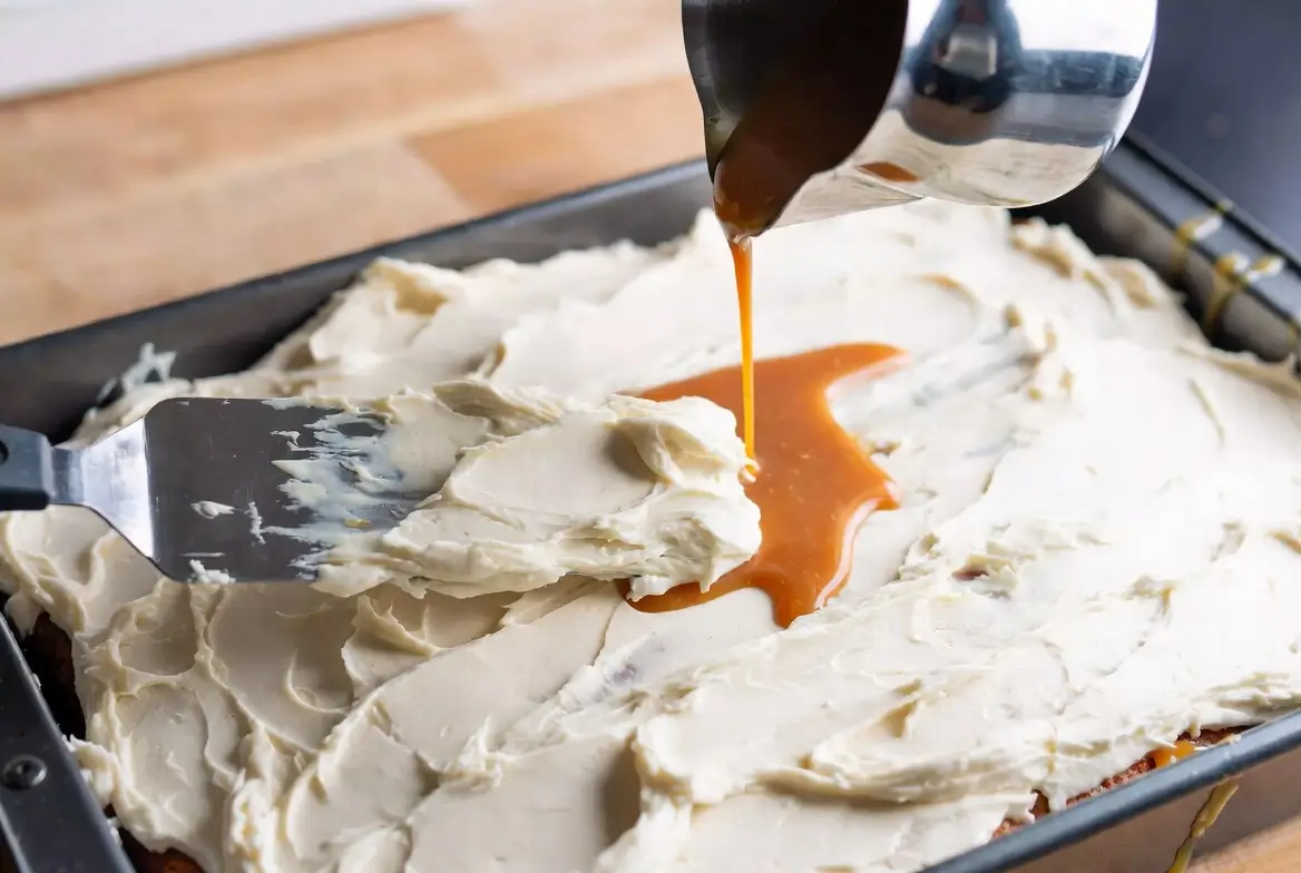 cream cheese frosting spread generously over cooled banana cake
